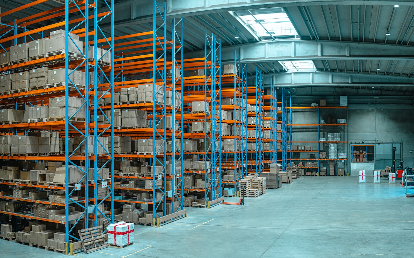 A warehouse aisle with racking neatly stacked with cartons
